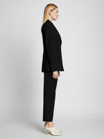 Side full length image of model wearing Upcycled Wool Blazer in BLACK