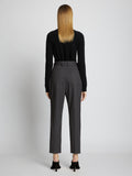 Back full length image of model wearing Upcycled Wool Carrot Pants in CHARCOAL