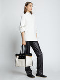Image of model carrying Large Morris Coated Canvas Tote in OFF WHITE