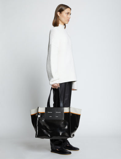 Image of model carrying XL Morris Coated Canvas Tote in BLACK