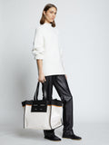 Image of model carrying XL Morris Coated Canvas Tote in OFF WHITE