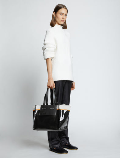 Image of model carrying Large Morris Coated Canvas Tote in BLACK