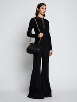 Image of model carrying Rolo Frame Clutch in BLACK