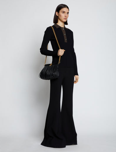 Image of model carrying Rolo Frame Clutch in BLACK
