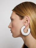 Image of model wearing LEATHER HOOP EARRINGS - OPTIC WHITE