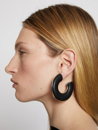 Proenza Schouler Image of model wearing Leather Hoop Earrings in black