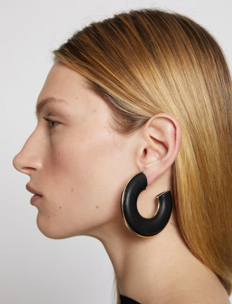 Proenza Schouler Image of model wearing Leather Hoop Earrings in black