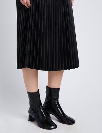 Detail image of model in Faux Leather Pleated Skirt in black