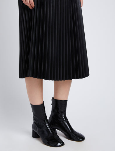 Detail image of model in Faux Leather Pleated Skirt in black