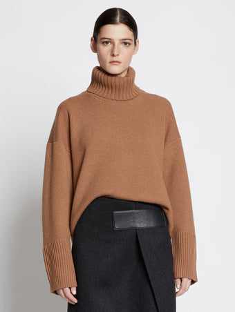 Front cropped image of model wearing Doubleface Eco Cashmere Oversized Turtleneck Sweater in SADDLE