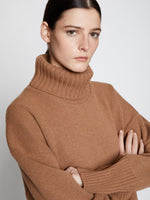 Detail image of model wearing Doubleface Eco Cashmere Oversized Turtleneck Sweater in SADDLE