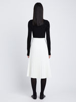Back image of model in Faux Leather Pleated Skirt in white