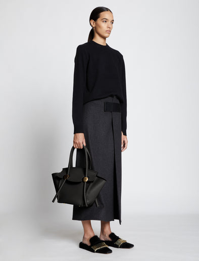 Image of model carrying Small Pipe Bag in BLACK