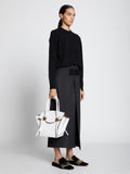 Image of model carrying Small Pipe Bag in OPTIC WHITE