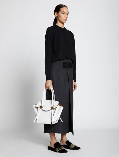 Image of model carrying Small Pipe Bag in OPTIC WHITE