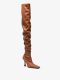 Front 3/4 image of thigh-length stiletto boots in Tan