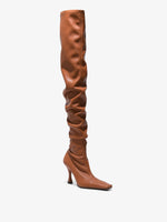 Front 3/4 image of thigh-length stiletto boots in Tan
