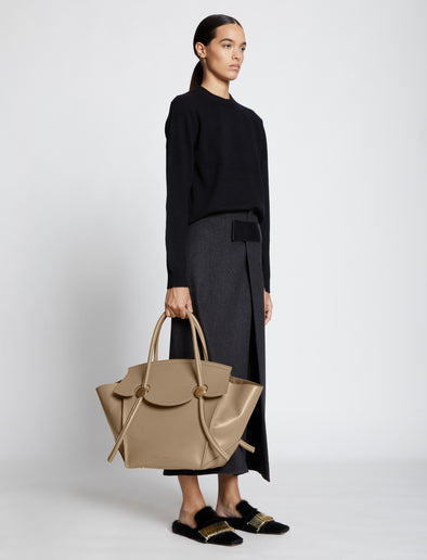 Image of model carrying Pipe Bag in LIGHT TAUPE