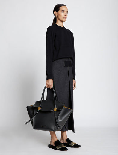 Image of model carrying Pipe Bag in BLACK