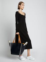 Image of model carrying XL Mercer Leather Tote in BLACK in hand