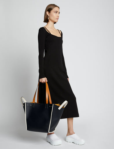 Image of model carrying XL Mercer Leather Tote in BLACK in hand