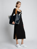 Image of model carrying XL Mercer Leather Tote in BLACK on shoulder