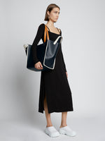 Image of model carrying XL Mercer Leather Tote in BLACK on shoulder