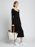 Image of model carrying Large Mercer Leather Tote in VANILLA in hand
