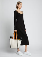 Image of model carrying Large Mercer Leather Tote in VANILLA in hand