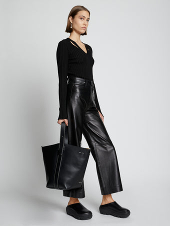 Image of model carrying Sullivan Leather Bag in BLACK in hand