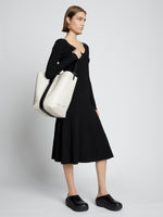 Image of model carrying Sullivan Leather Bag in VANILLA on shoulder