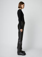 Side full length image of model wearing Leather Straight Pant in BLACK