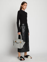 Image of model carrying Small Pipe Bag in drizzle