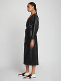 Side full length image of model wearing Faux Leather Wrap Dress in BLACK