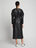Back full length image of model wearing Faux Leather Wrap Dress in BLACK