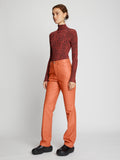 Side full length image of model wearing Leather Straight Pants in TERRACOTTA