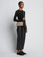 Image of model carrying Watts Leather Camera Bag in CLAY crossbody