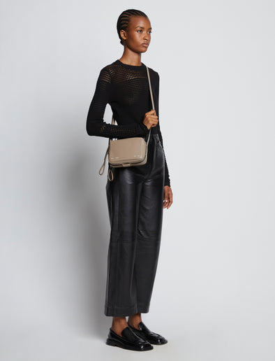 Image of model carrying Watts Leather Camera Bag in CLAY crossbody