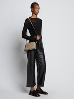 Image of model carrying Watts Leather Camera Bag in CLAY