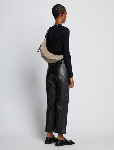 Image of model carrying Stanton Leather Sling Bag in CLAY across back