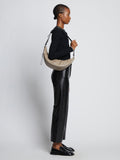 Image of model carrying Stanton Leather Sling Bag in CLAY