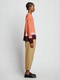 Side full length image of model wearing Rib Knit Dip Dye Sweater in SALMON MULTI