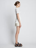 Side full length image of model wearing Tweed Mini Skirt in OFF WHITE