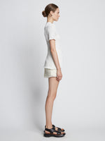 Side full length image of model wearing Tweed Mini Skirt in OFF WHITE