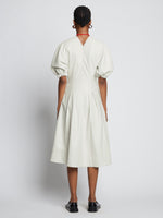 Back full length image of model wearing Faux Leather Puff Sleeve Dress in OFF WHITE