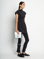 Image of model carrying Embossed Croc Dia Day Bag in pale blue