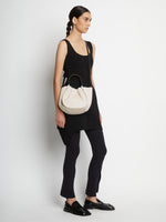 Image of model carrying Small Ruched Crossbody Tote in CLAY on shoulder