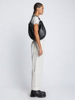 Image of model carrying Baxter Leather Bag in BLACK in hand