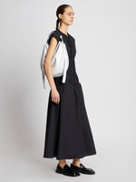 Image of model carrying Baxter Leather Bag in OPTIC WHITE in hand
