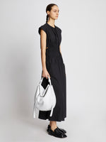 Image of model carrying Baxter Leather Bag in OPTIC WHITE on shoulder